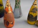 five vases with different designs on them sitting on a table