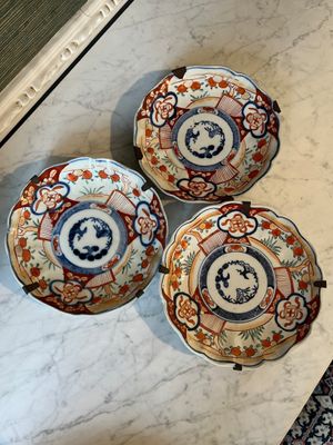 three plates are sitting on a table with a mirror in the background