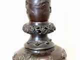 a large bronze vase on top of a table