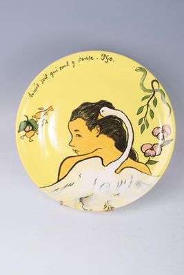 a yellow plate with a picture of a woman and a bird on it