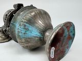 a silver vase with a blue and red design on it