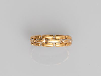 a close up of a gold ring on a white surface