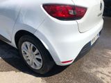 the rear end of a white car parked in a parking lot