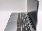 a silver laptop with a black keyboard on a white surface
