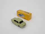 an image of a green toy car next to a box on a white surface