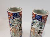 two vases that are sitting on a table