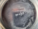 a close up of a silver plate with a name written on it