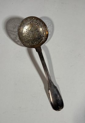 a spoon and a spoon rest on a white table