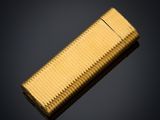 a close up of a gold lighter on a black background