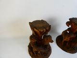 two pieces of wood sitting on a white surface