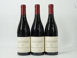 three bottles of wine sitting on top of a white table