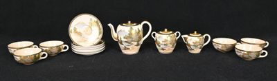 a group of silver and gold tea and coffee cups and saucers