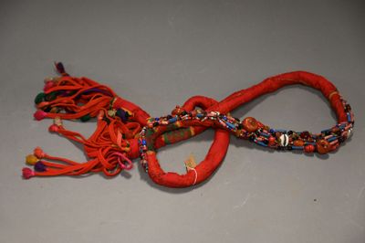 a red rope with a knot on it on a table