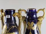 two blue vases with gold designs on them