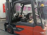a red fork truck parked in front of a building