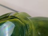 a close up of a green glass sculpture of a frog