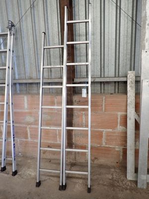 three ladders that are leaning up against a wall