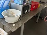 a woman standing in a kitchen next to a counter with a bowl on it