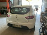 a white car parked in a garage next to a bike