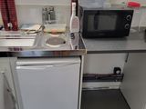 a small kitchen with a microwave, dishwasher, dishwasher, and dishwasher