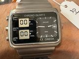 a watch on a man ' s wrist with a price tag on it