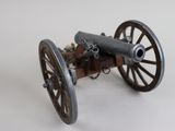 a toy cannon sitting on top of a wooden cart