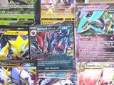 a lot of different pokemon cards on the table