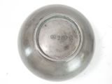 a silver plate with a silver lid sitting on a table