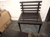a black chair that is next to a cardboard box