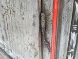 a close up of a door handle on a wooden door