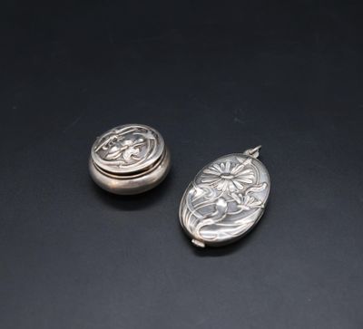 two silver lockes sitting on top of a black surface