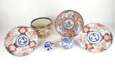 an image of a group of asian plates and bowls on a white surface