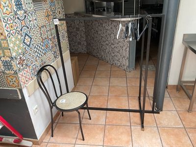 a chair and a table in a room with tiled walls