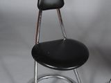 a black chair that has a black seat on it