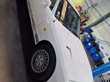 a white car that is parked in a garage