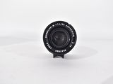 a black camera lens sitting on a white surface