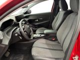 the interior of a red car with a steering wheel and dashboard