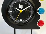 a black clock with multi colored balls on it