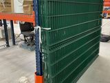 a close up of a large green radiator in a warehouse