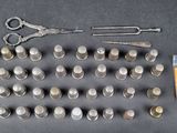 a lot of coins and a pair of scissors on the table