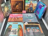 various album covers are on display on a table in a display case