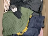 a box full of clothes that is sitting on the floor