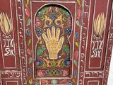 a red cabinet with a hand painted design on it
