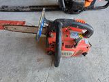 two chainsaws sitting on the floor next to each other