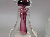 two glass figurines that are sitting next to each other