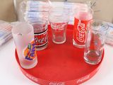 a tray that has a tray of coca cola glasses on it