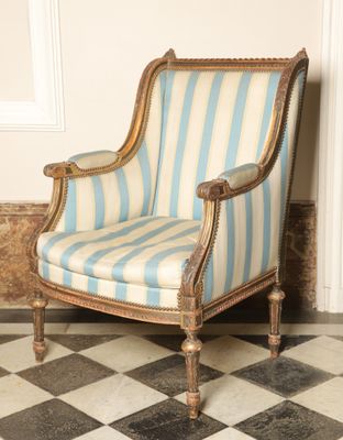 an image of a blue and white striped chair sitting on a black and white checkered floor