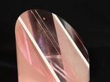 a picture of a pink and white glass object on a black background