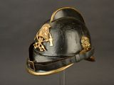 a black helmet with a gold emblem on it