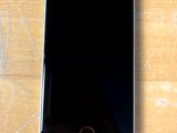 a cell phone that is sitting on a wooden table